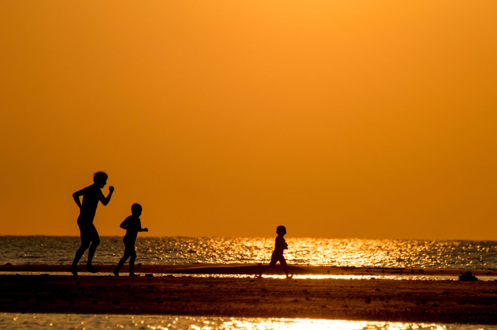 walking during sunrise on the beach - Thomas Beach Vacations, North Myrtle Beach