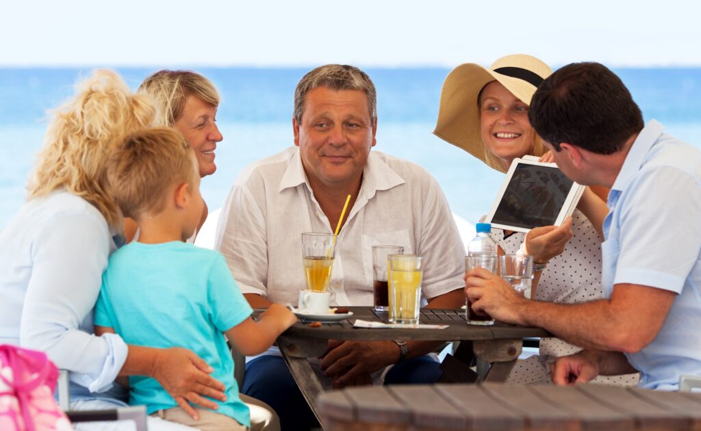 Family eating at restaurant at the beach - Thomas Beach Vacations